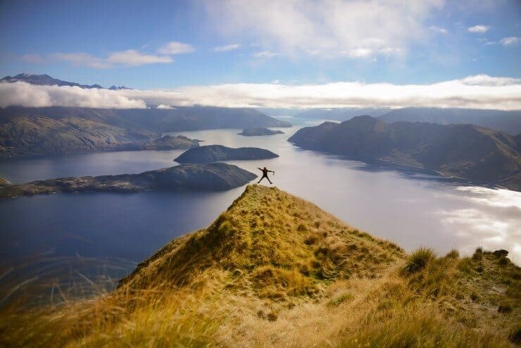 Star jumping on top of the world at Roy's Peak overlooking Lake Wanaka.
