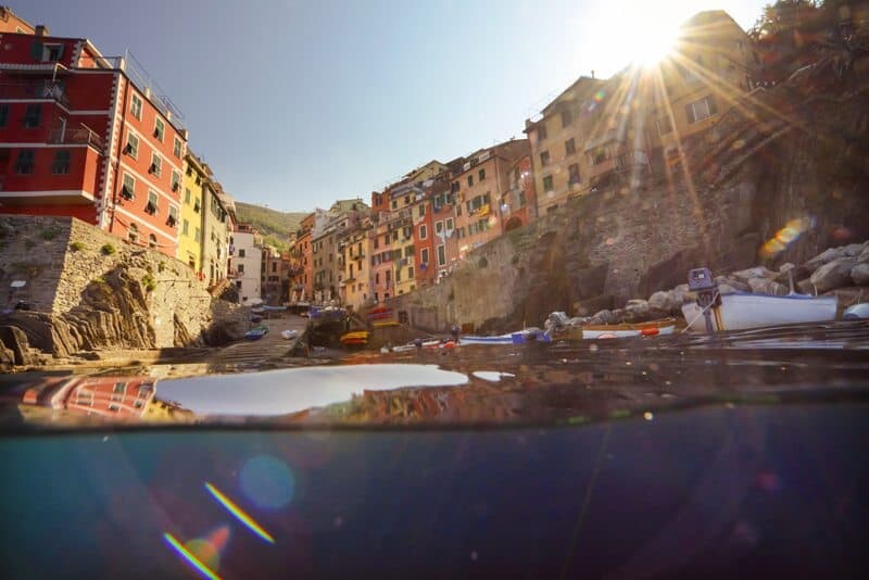 Morning light creeps over the colourful buildings of Riomaggiore, Cinque Terre.