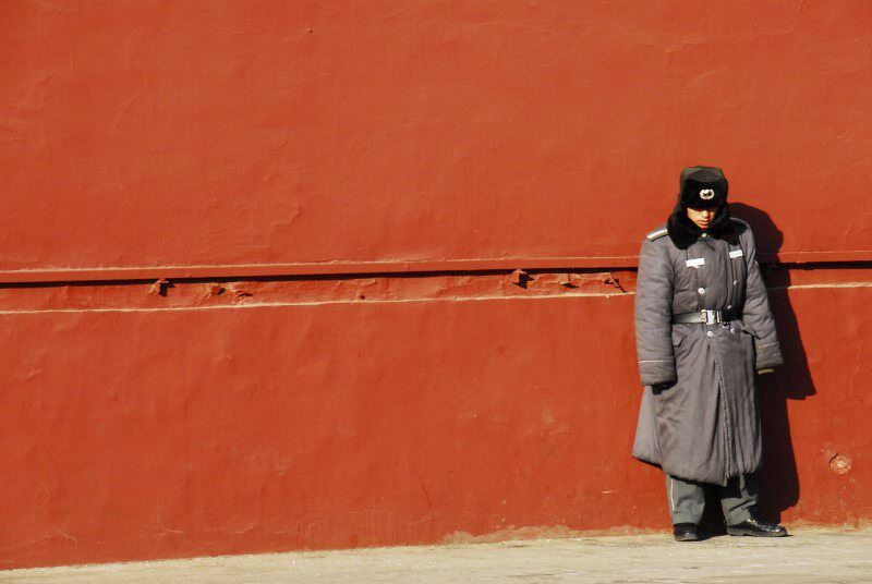This guard at Beijing's Forbidden City with his grey uniform against the rich red wall. By composing him slightly right of centre it enhances the image and the effect of the contrasting colours.