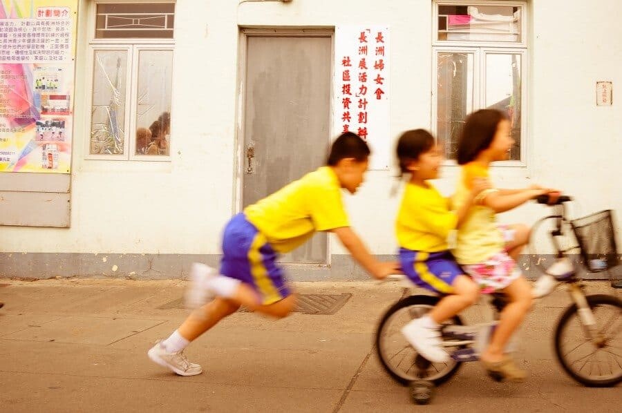 Cheung Chau Island, Hong Kong: This island is filled with bicycles and I wanted to capture a shot that showed this along with the happy nature of the people who lived there. I'd captured another shot but then these children rode past squealing with excitement on their way home from school.
