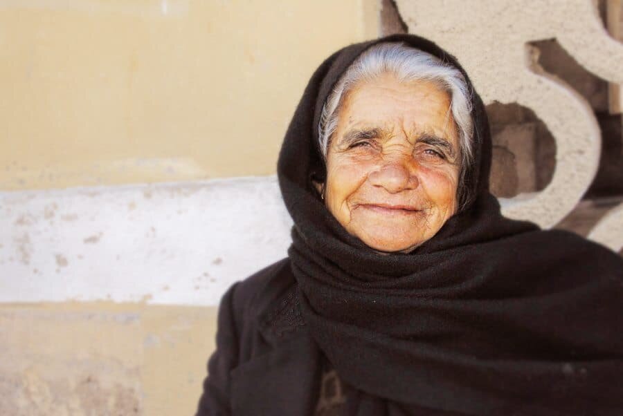 Crete, Greece: After seeing her beautiful face watching people walk by, I couldn't resist approaching this woman to take her portrait. Smiling happily, you can almost feel the stories in her eyes.