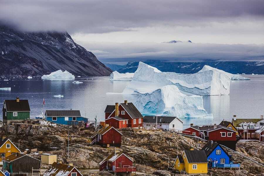 Massive icebergs and colourful houses in Uummannaq, Greenland