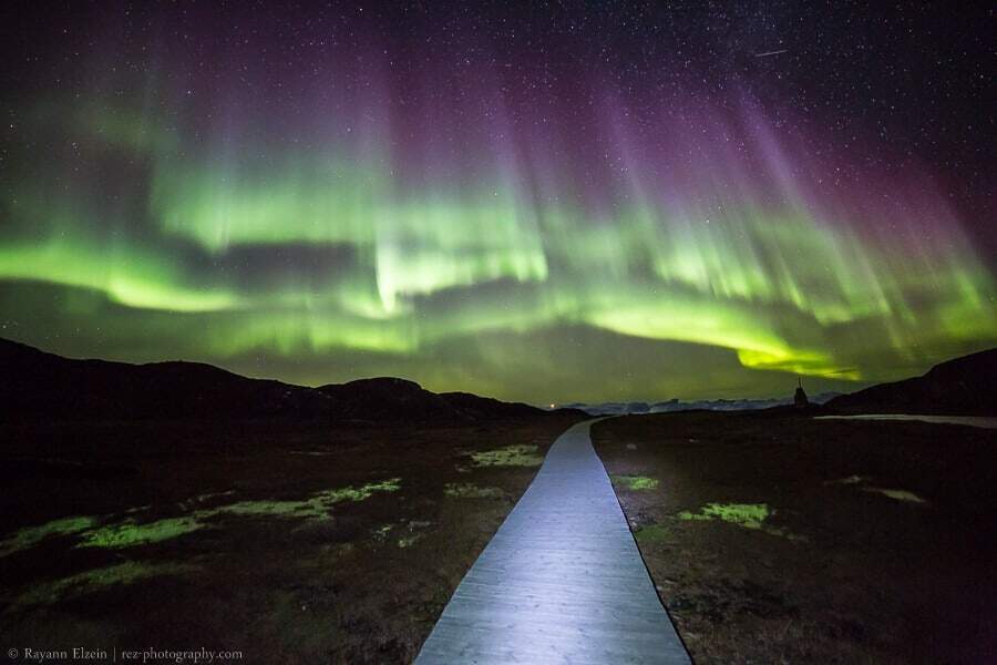 Aurora borealis above the boardwalks of the Unesco Ilulissat Icefjord in Greenland