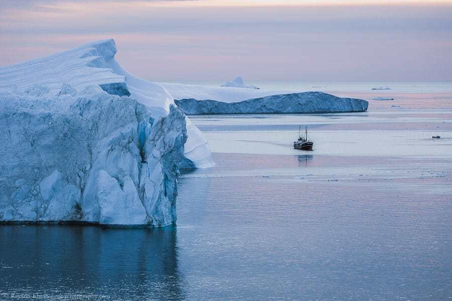 Boat and icebergs in the UNESCO Ilulissat Icefjord in Greenland