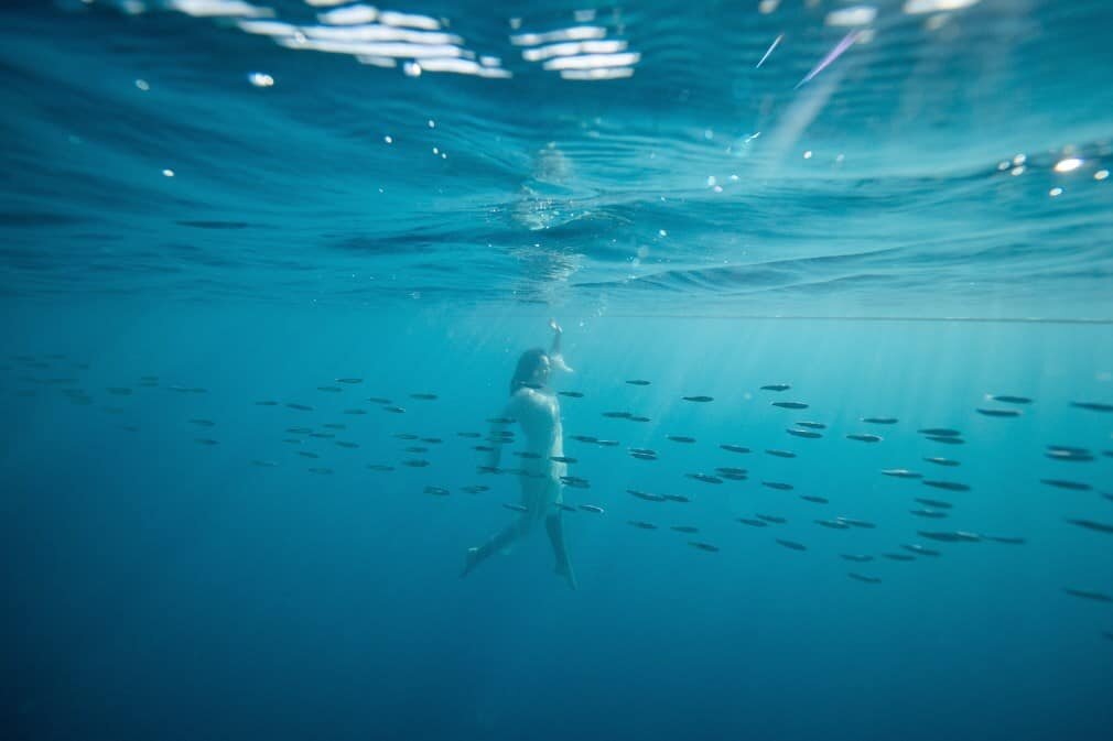 Underwater Photography Great Barrier Reef, model in white dress dancing underwater, photography by Lisa Michele Burns